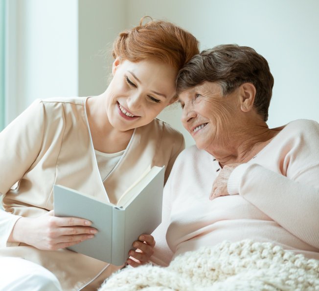 caregiver and senior reading