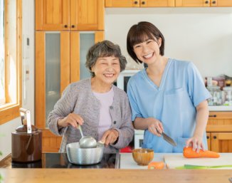 caregiver and senior cooking 