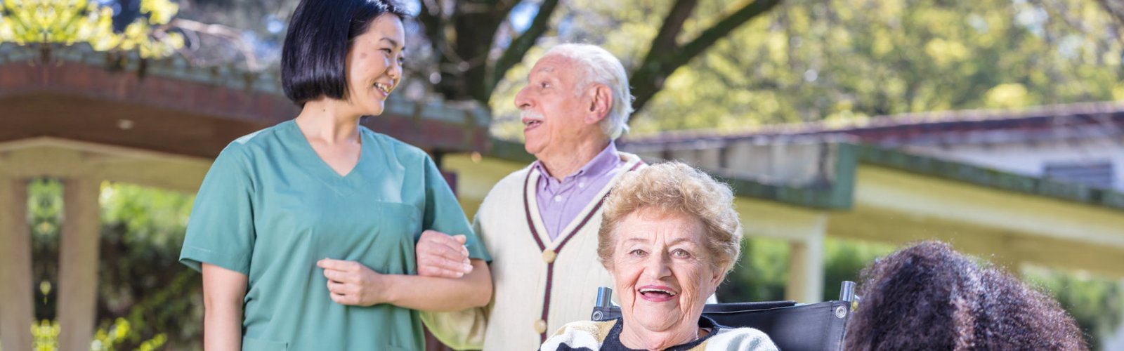 caregiver and seniors on public park